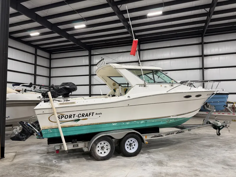 Slide: The Image of A 1999 Sport-Craft Sportsman boat on a trailer inside a storage facility. - 1