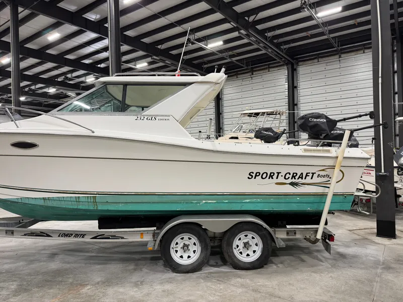 Slide: The Image of A 1999 Sport-Craft Sportsman boat on a trailer in a warehouse setting. - 3