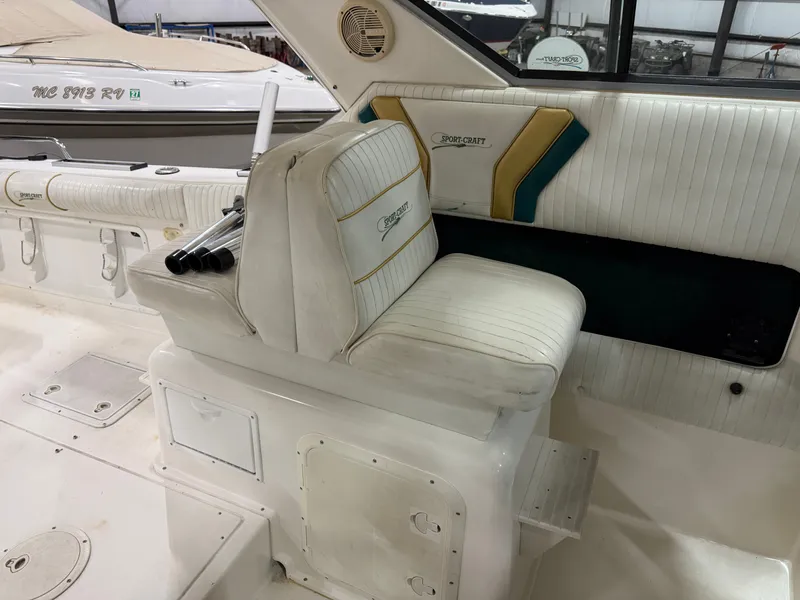 Slide: The Image of Interior of a 1999 Sport-Craft Sportsman with white upholstery and green-yellow accents. - 8