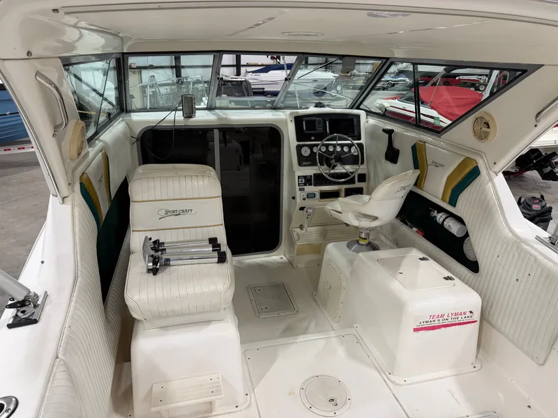 Slide: The Image of Interior of a 1999 Sport-Craft Sportsman with helm, seating, and instrument panel. - 6
