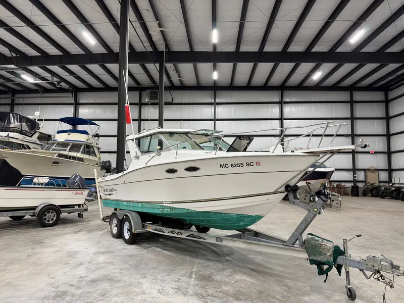 The Image of A 1999 Sport-Craft Sportsman boat on a trailer inside a warehouse. - 0
