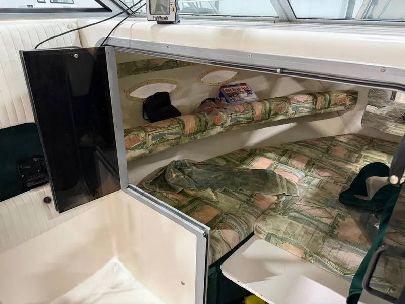 Slide: The Image of Interior of a 1999 Sport-Craft Sportsman with sleeping area and storage. - 11