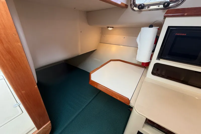 Slide: The Image of Interior cabin of 2006 Albin 28 Gatsby Edition boat, featuring compact kitchenette and cozy sleeping area. - 33
