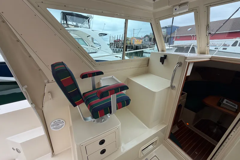 Slide: The Image of Interior of 2006 Albin 28 Gatsby Edition boat with striped seating and cabin view. - 24