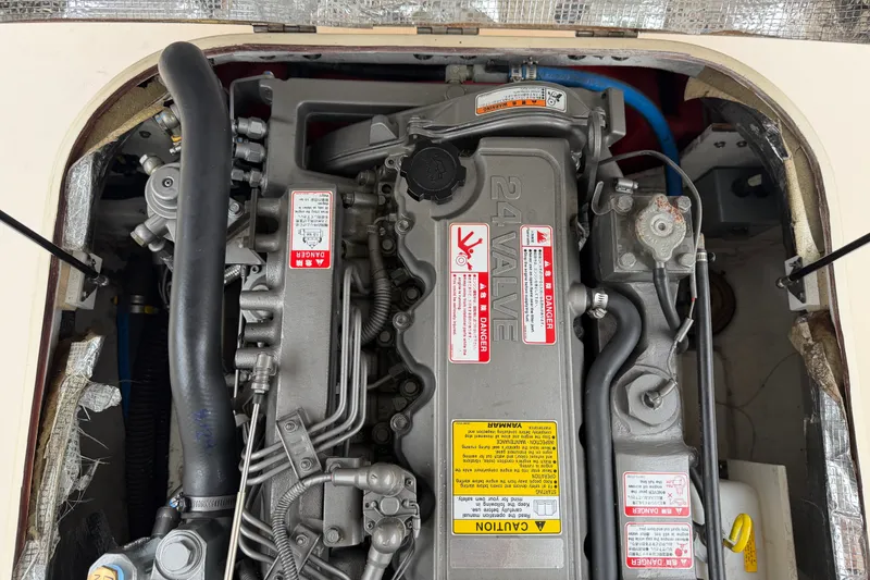 Slide: The Image of Engine compartment of a 2006 Albin 28 Gatsby Edition boat, showcasing detailed mechanical components. - 53
