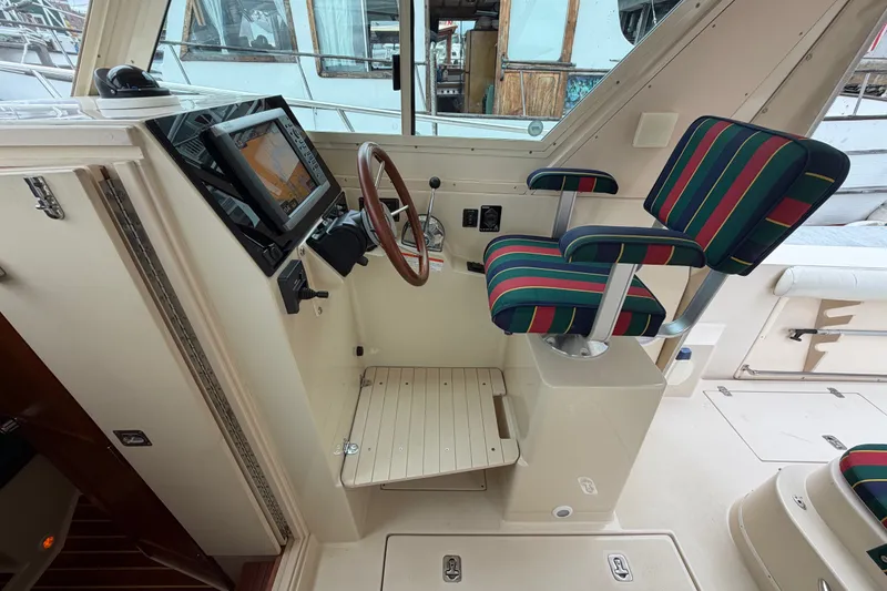 Slide: The Image of Interior of 2006 Albin 28 Gatsby Edition boat with striped seating and navigation controls. - 29