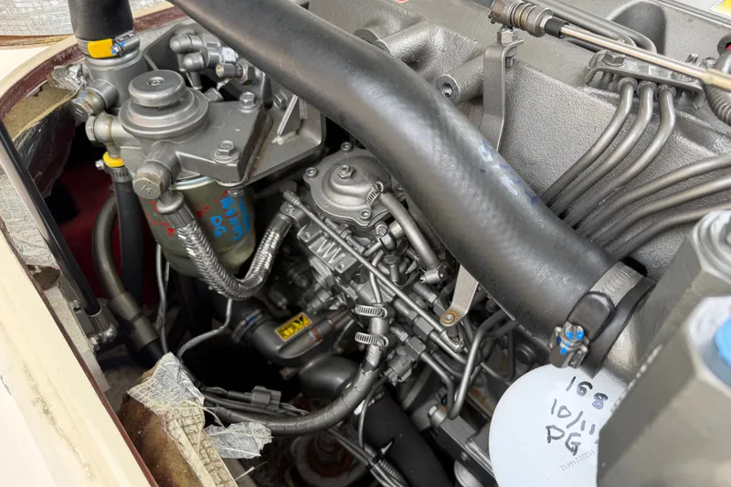 Slide: The Image of Engine compartment of a 2006 Albin 28 Gatsby Edition boat, showcasing detailed mechanical components. - 55