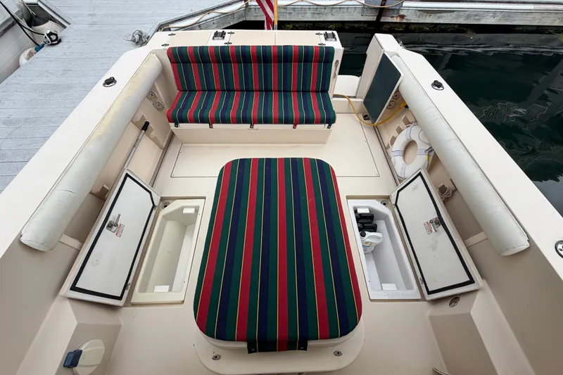 Slide: The Image of 2006 Albin 28 Gatsby Edition boat interior with striped seating and storage compartments. - 58