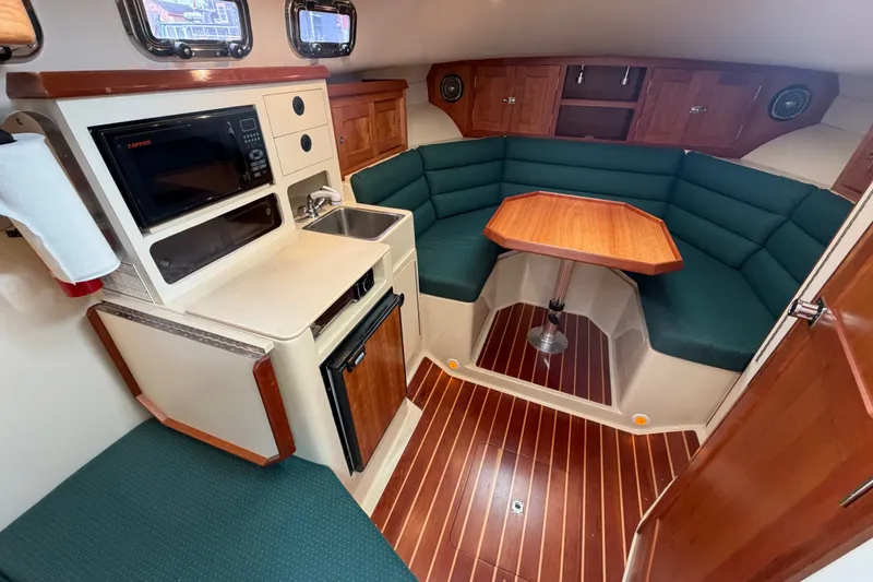 Slide: The Image of Interior of 2006 Albin 28 Gatsby Edition boat with kitchenette and seating area. - 30