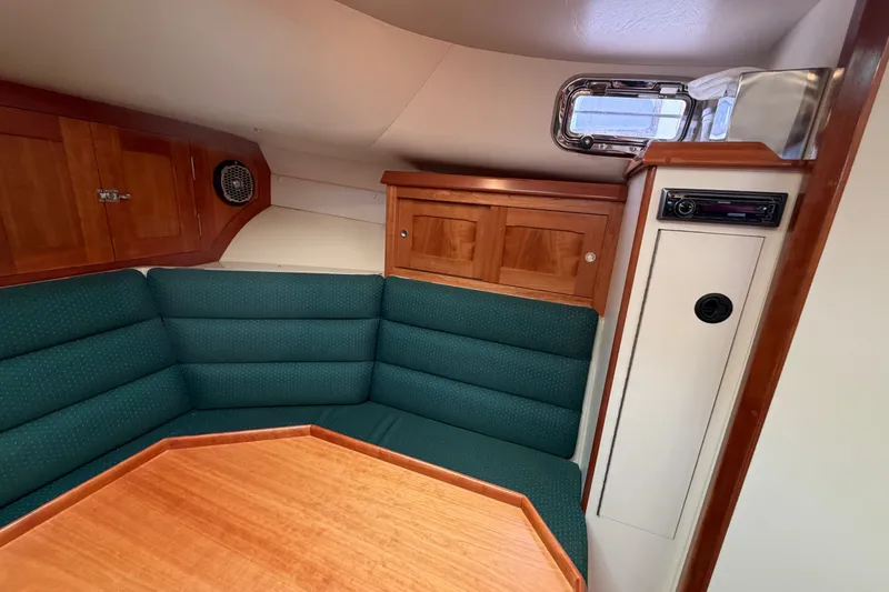 Slide: The Image of Interior of 2006 Albin 28 Gatsby Edition with green seating and wooden cabinetry. - 35