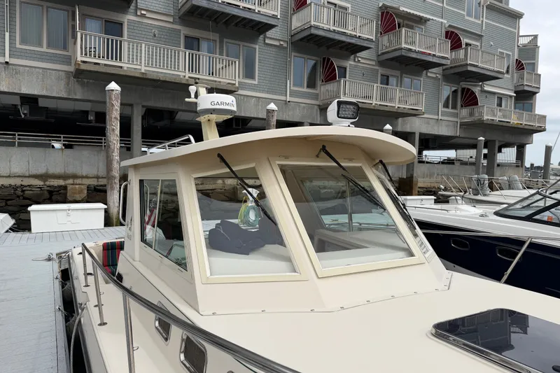 Slide: The Image of 2006 Albin 28 Gatsby Edition docked near waterfront building. - 64