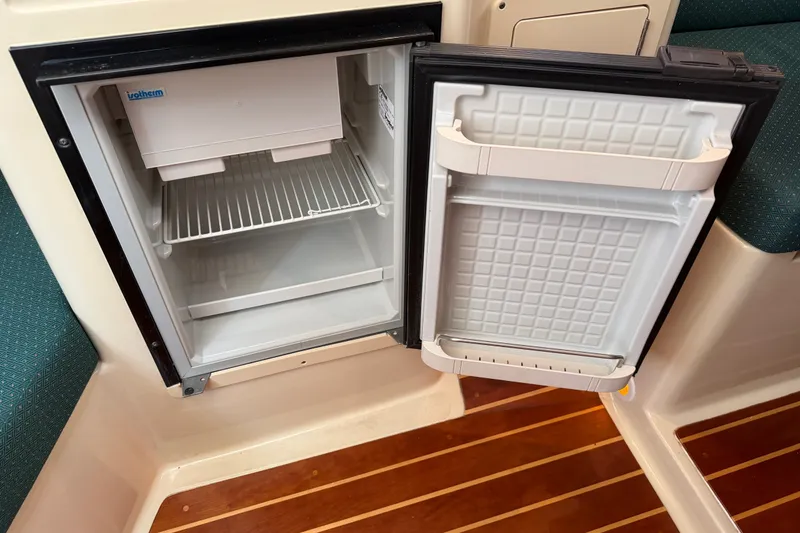 Slide: The Image of Open refrigerator inside 2006 Albin 28 Gatsby Edition boat, showcasing interior shelves. - 41