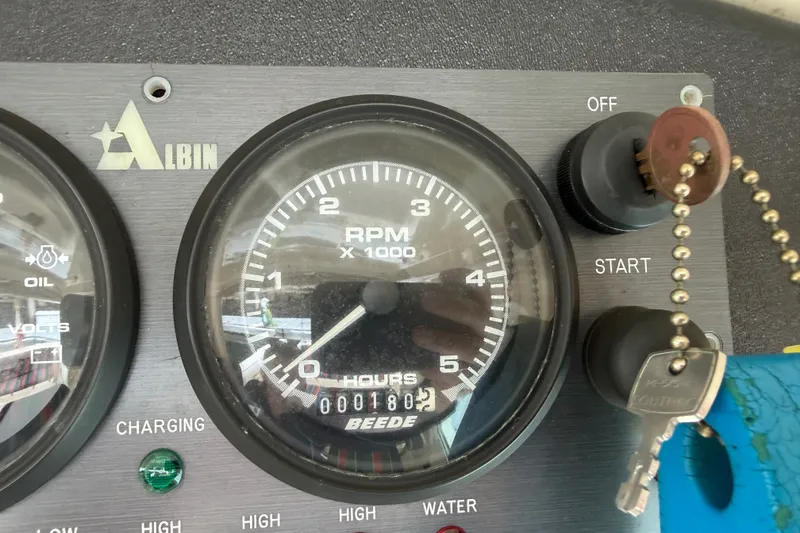 Slide: The Image of Instrument panel of 2006 Albin 28 Gatsby Edition showing RPM gauge and ignition keys. - 28