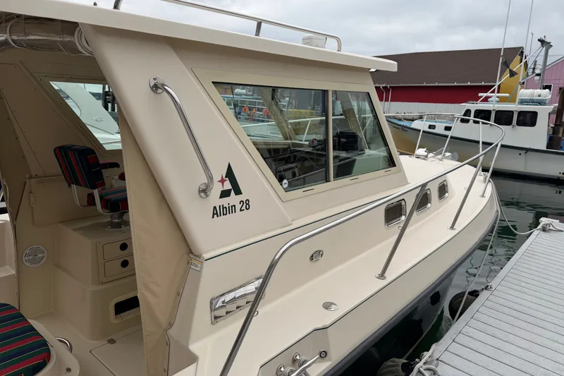 Slide: The Image of 2006 Albin 28 Gatsby Edition boat docked at a marina, featuring sleek design and spacious cabin. - 62