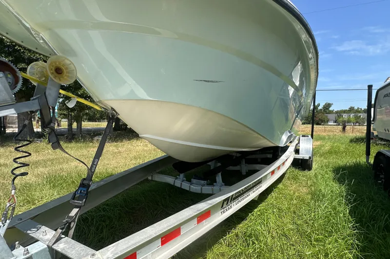 Slide: The Image of 2012 Sundance NX25 boat on trailer in grassy area, sunny day. - 45