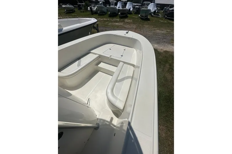 Slide: The Image of 2012 Sundance NX25 boat interior with seating and storage, displayed outdoors. - 29