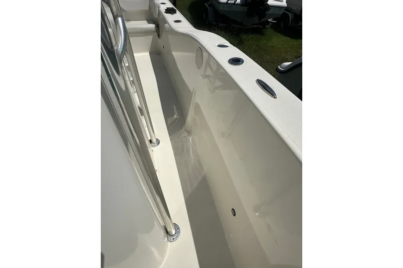 Slide: The Image of Interior view of a 2012 Sundance NX25 boat, showcasing sleek design and stainless steel fittings. - 36