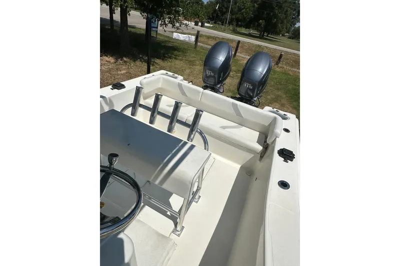 Slide: The Image of 2012 Sundance NX25 boat with dual 175 horsepower engines, featuring a spacious deck and steering console. - 38