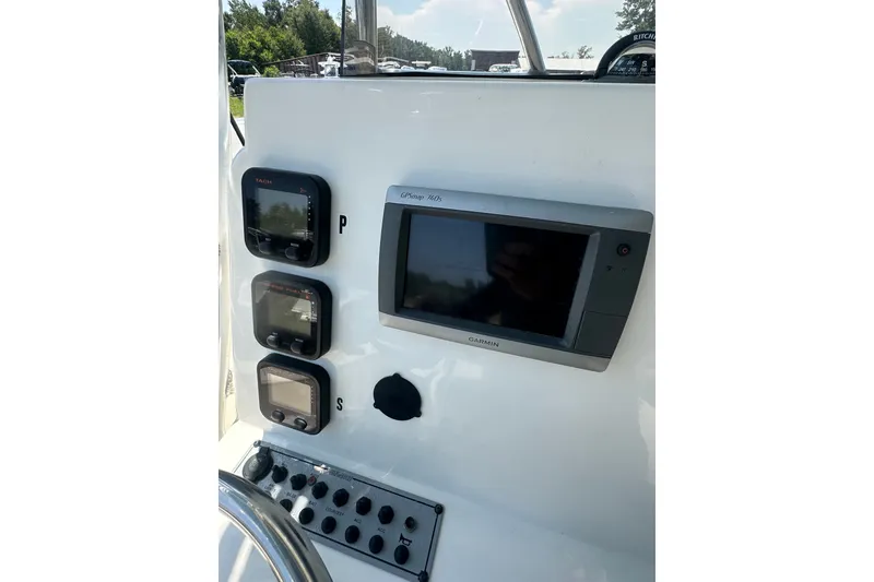 Slide: The Image of 2012 Sundance NX25 boat dashboard with Garmin GPS and control panel. - 26
