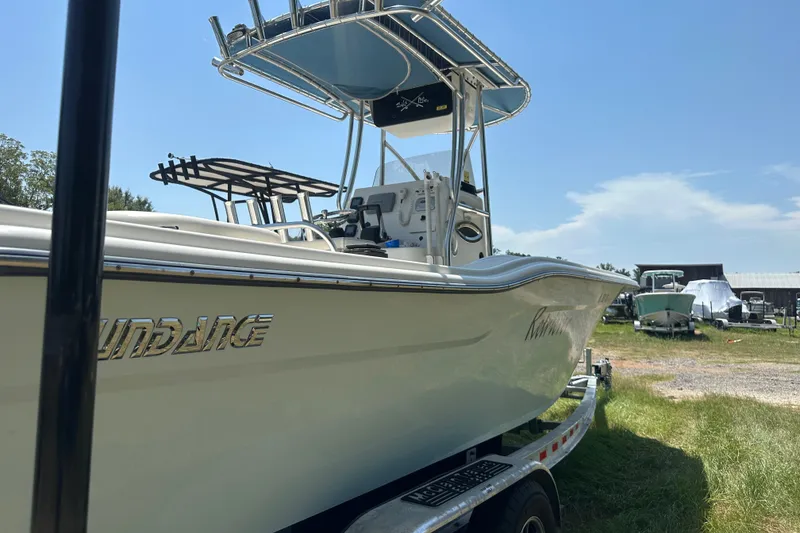 Slide: The Image of 2012 Sundance NX25 boat on trailer in sunny outdoor setting. - 46