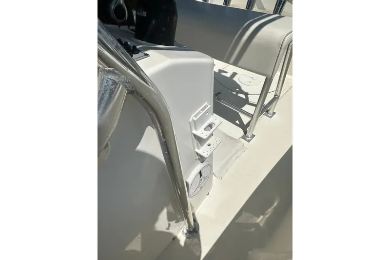 Slide: The Image of Interior view of a 2012 Sundance NX25 boat, featuring seating and metal railings. - 37