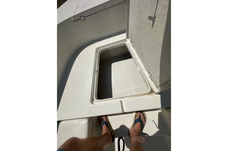 Slide: The Image of Open storage compartment on 2012 Sundance NX25 boat deck. - 32