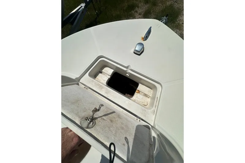 Slide: The Image of Open hatch on 2012 Sundance NX25 boat deck, showing storage compartment. - 31