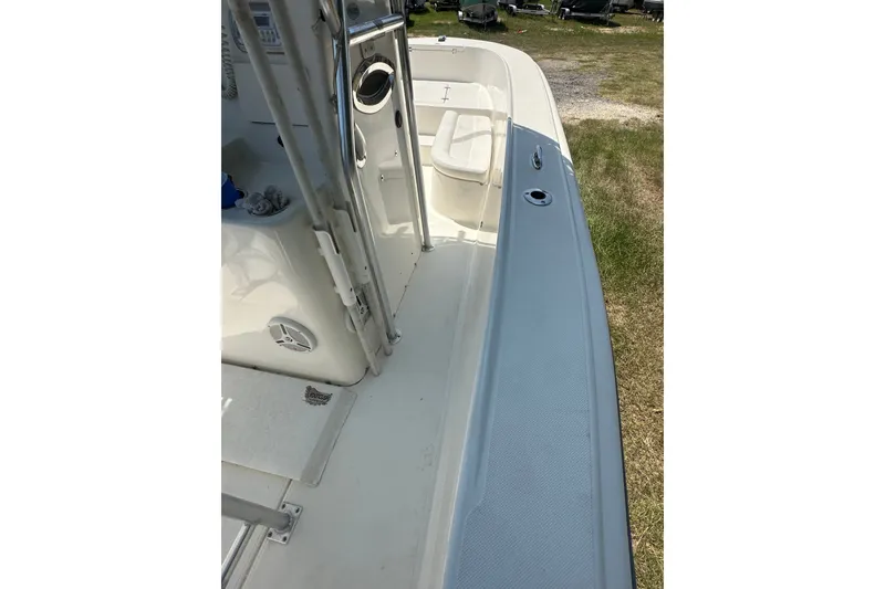 Slide: The Image of 2012 Sundance NX25 boat deck with clean white surface and stainless steel fittings. - 24