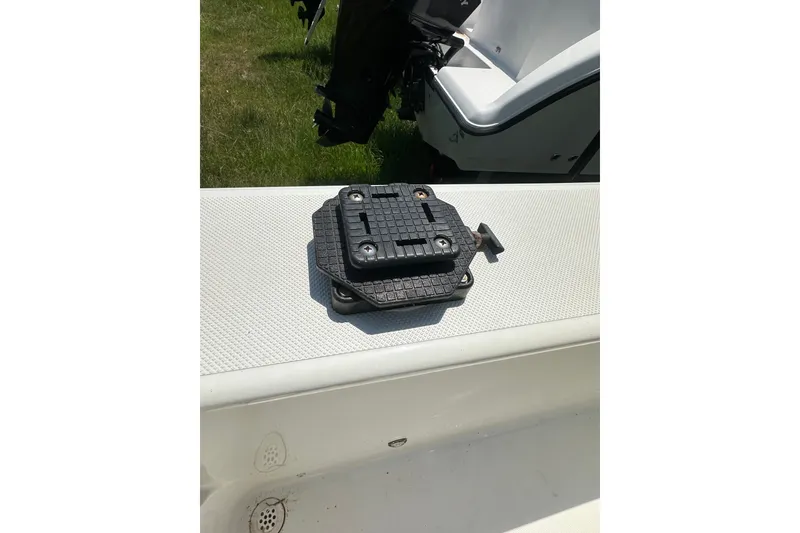 Slide: The Image of Sundance NX25 boat part on deck, 2012 model, with motor in background. - 22