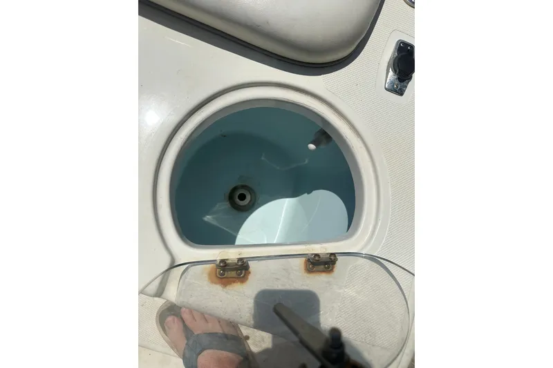 Slide: The Image of Open hatch on 2012 Sundance NX25 boat, showing interior compartment. - 41
