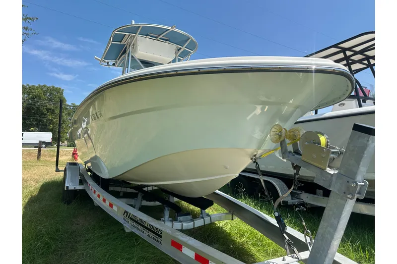 Slide: The Image of 2012 Sundance NX25 boat on trailer under clear blue sky. - 43