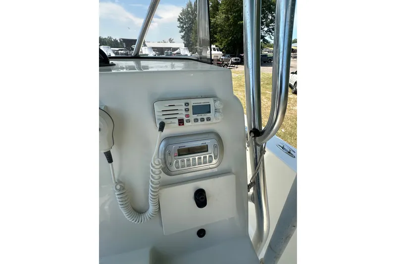 Slide: The Image of Control panel of a 2012 Sundance NX25 boat with radio and navigation equipment. - 27