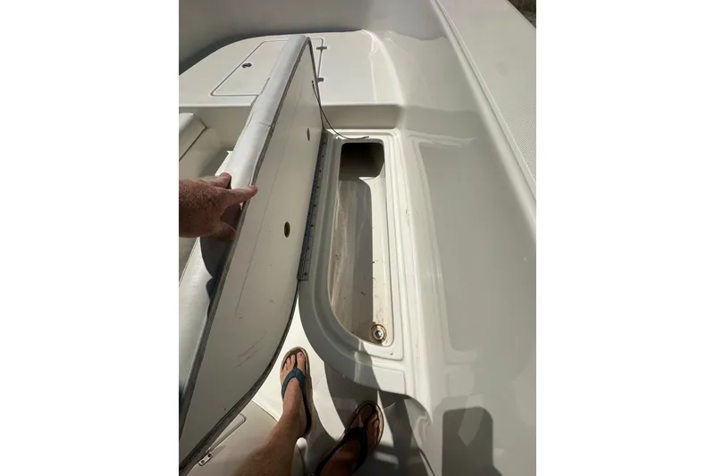 Slide: The Image of Open storage compartment on 2012 Sundance NX25 boat deck. - 30