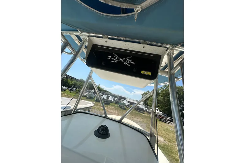 Slide: The Image of 2012 Sundance NX25 boat console with compass and storage compartment. - 28