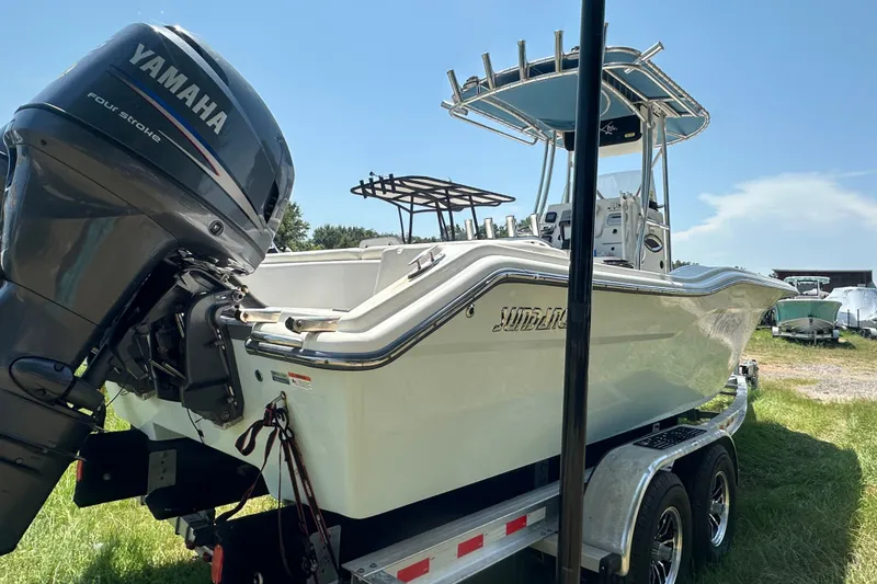 Slide: The Image of 2012 Sundance NX25 boat with Yamaha engine on trailer, parked outdoors. - 47