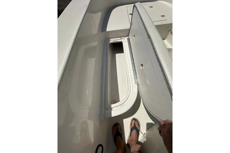 Slide: The Image of Open storage compartment on 2012 Sundance NX25 boat deck. - 33
