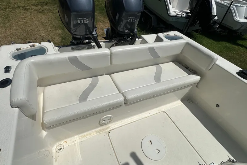 Slide: The Image of 2012 Sundance NX25 boat interior with Yamaha 115 engines, featuring white cushioned seating. - 20