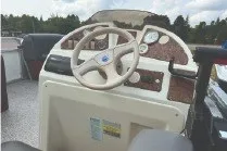 Slide: The Image of Steering console of a 2000 Tahoe Pontoon boat with gauges and controls. - 12