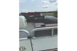 Slide: The Image of 2000 Tahoe Pontoon boat with seating, under a partly cloudy sky. - 9