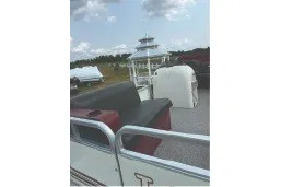 Slide: The Image of 2000 Tahoe Pontoon boat with seating, under a partly cloudy sky. - 16