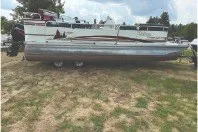Slide: The Image of 2000 Tahoe Pontoon boat on grassy area, ready for transport. - 4