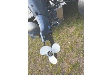 Slide: The Image of Outboard motor propeller of a 2000 Tahoe Pontoon boat on grass. - 8