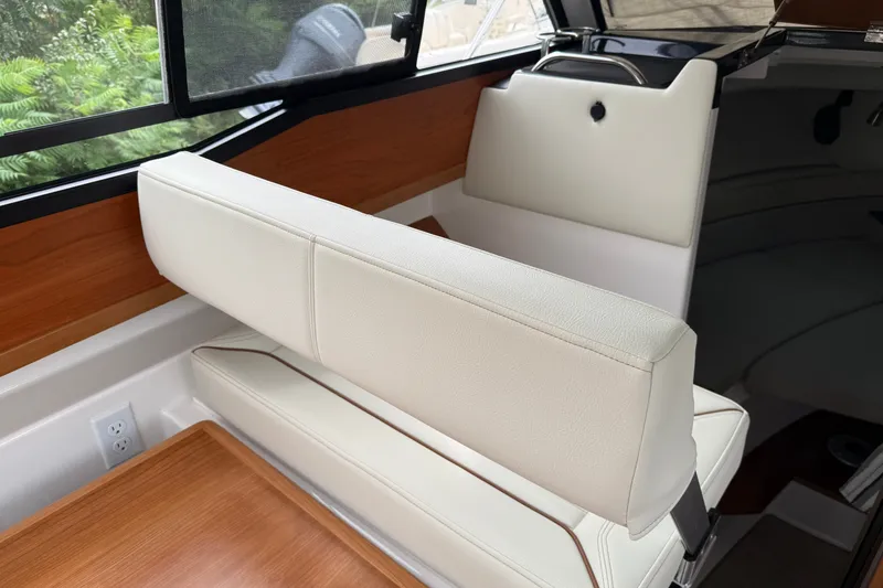 Slide: The Image of Interior of 2026 Cutwater C-248 Coupe with white seating and wood accents. - 13