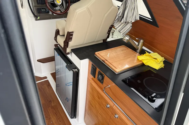 Slide: The Image of Interior of 2026 Cutwater C-248 Coupe featuring kitchenette and helm station. - 10