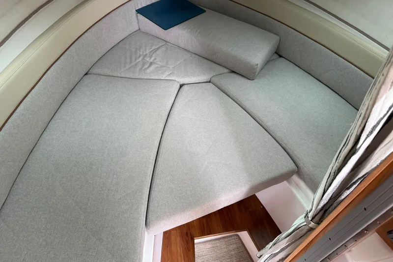 Slide: The Image of 2026 Cutwater C-248 Coupe interior cabin with gray cushions and wooden flooring. - 14