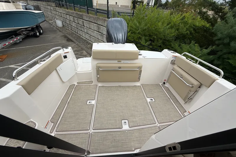 Slide: The Image of 2026 Cutwater C-248 Coupe boat deck with beige seating and modern design. - 18