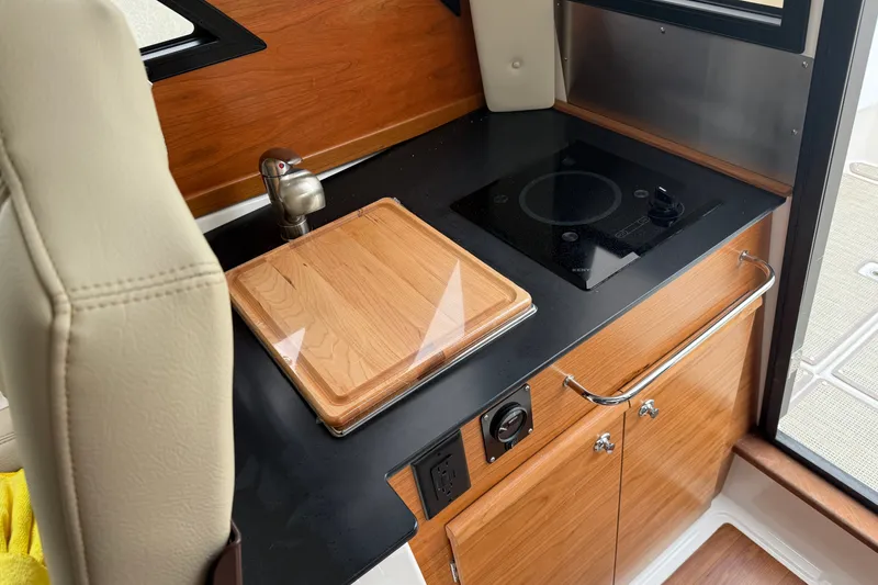 Slide: The Image of Compact kitchen area in 2026 Cutwater C-248 Coupe with stove and sink. - 17