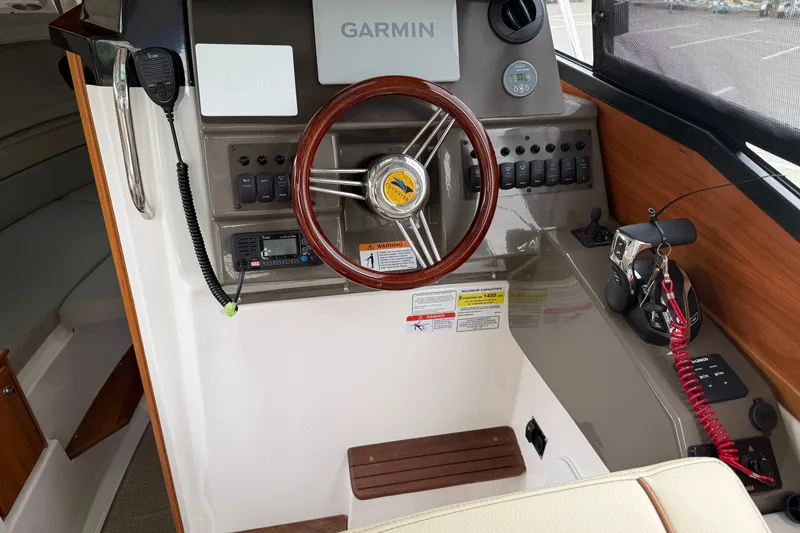 Slide: The Image of 2026 Cutwater C-248 Coupe helm with Garmin navigation and wood-accented steering wheel. - 12