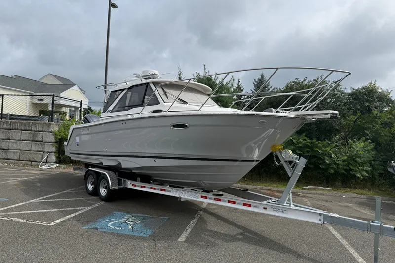 Slide: The Image of 2026 Cutwater C-248 Coupe boat on trailer in parking lot. - 1