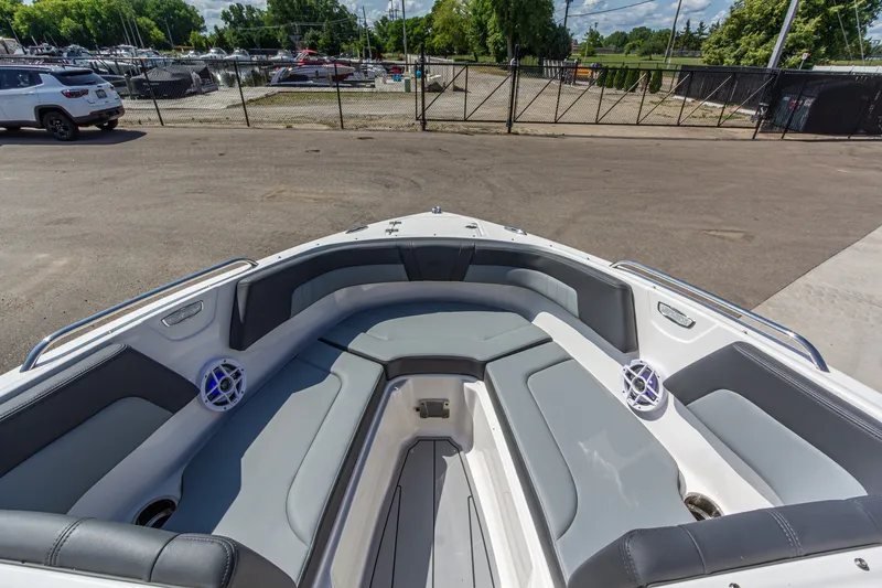 Slide: The Image of 2026 Chaparral 23 SSi boat interior with gray seating and speakers, docked at marina. - 31